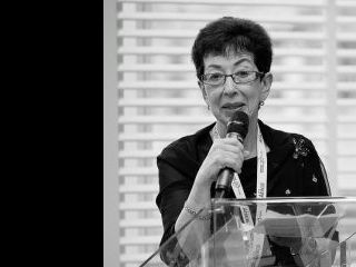 Nancy Hafkin holding a microphone.