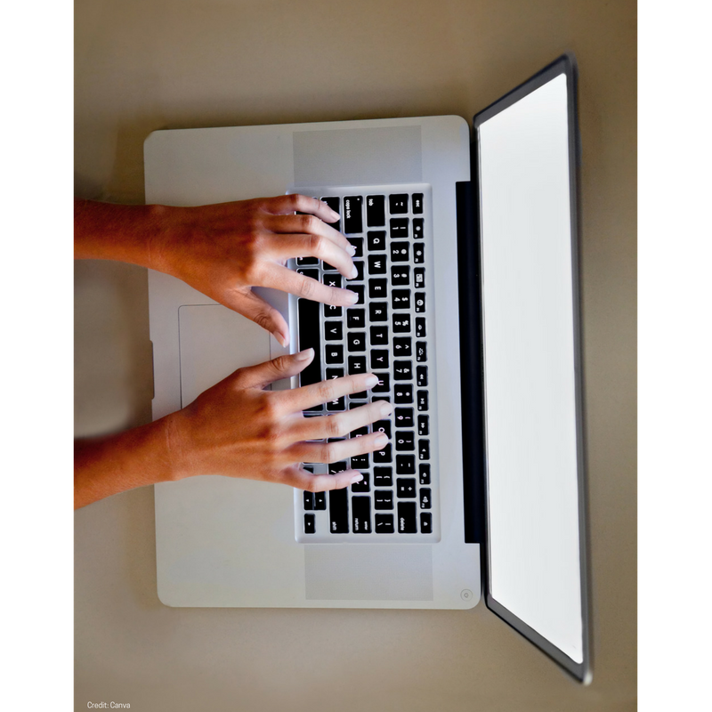 Two hands on the laptop seen from above. 