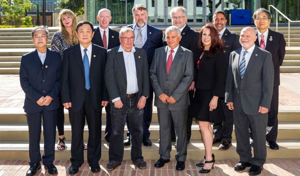 a group of people stand for picture outside