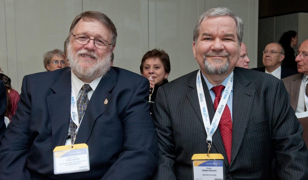 two people sitting side by side smiling