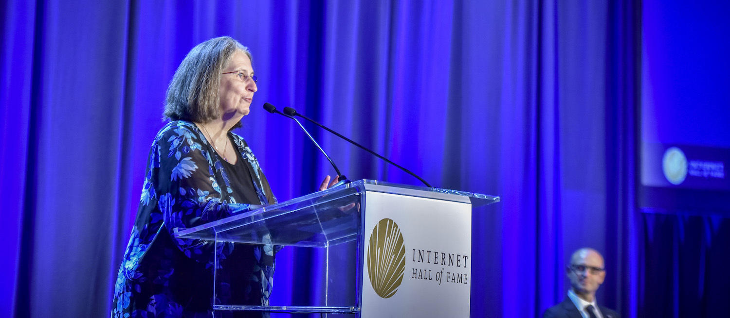 a woman on a stage talking