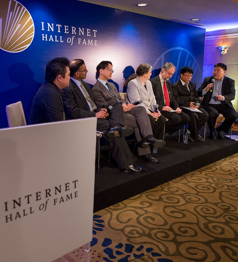 a group of people sitting and talking at stage