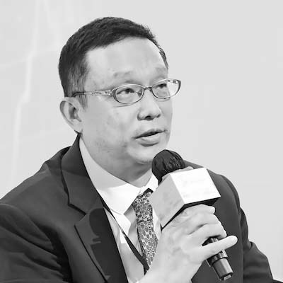 a man with glasses and a microphone in his hand