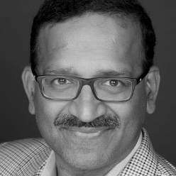 a man with a mustache wearing glasses