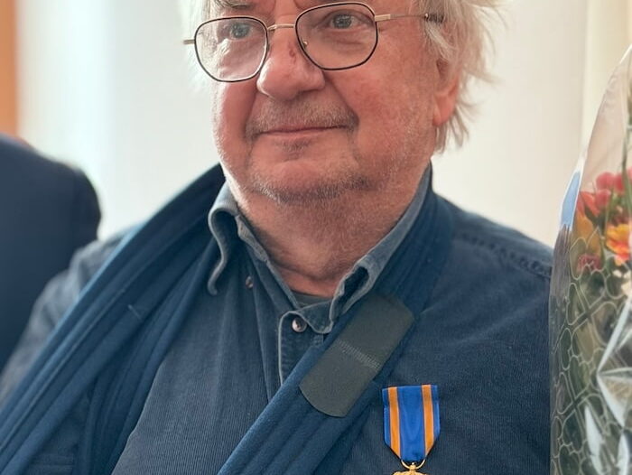 a man decorated with the Order of the Dutch Lion star